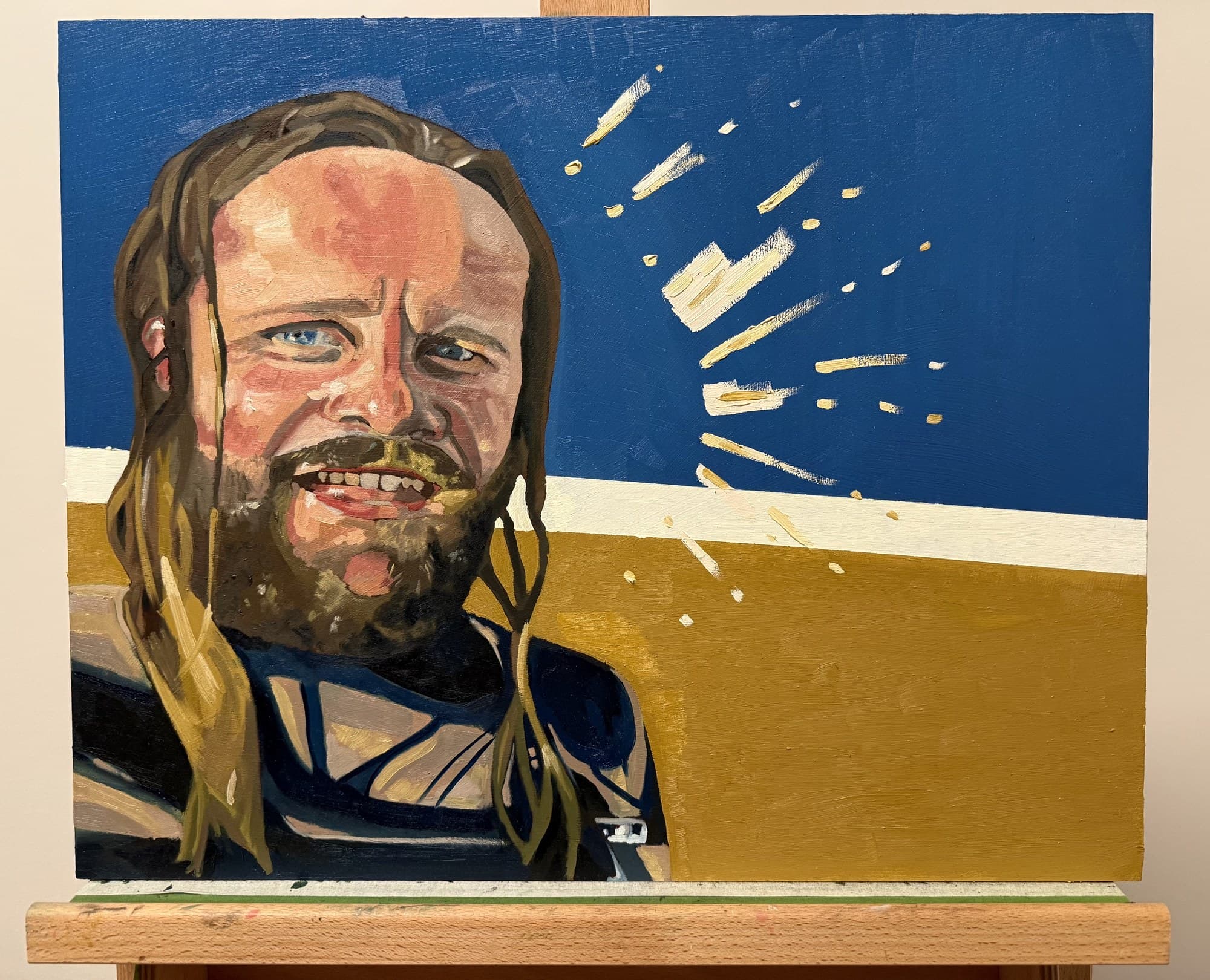 Oil self-portrait — bearded figure with long hair laughing, against a blue and ochre background with a burst of cream brushstrokes